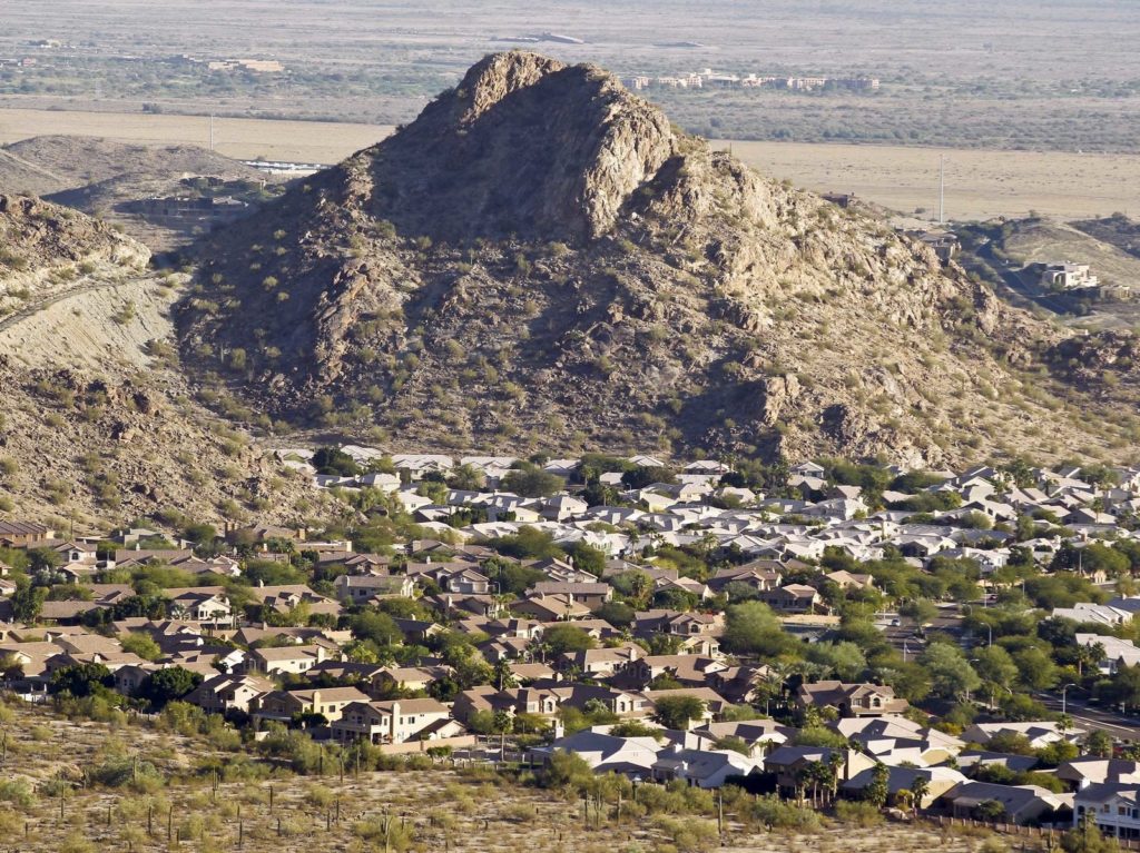 A housing development sits nestled in the South Mountain foothills in the Ahwatukee neighborhood, in Phoenix, Ariz. The city saw the biggest jump in population in the U.S. between 2017 and 2018. CREDIT: Ross D. Franklin/AP