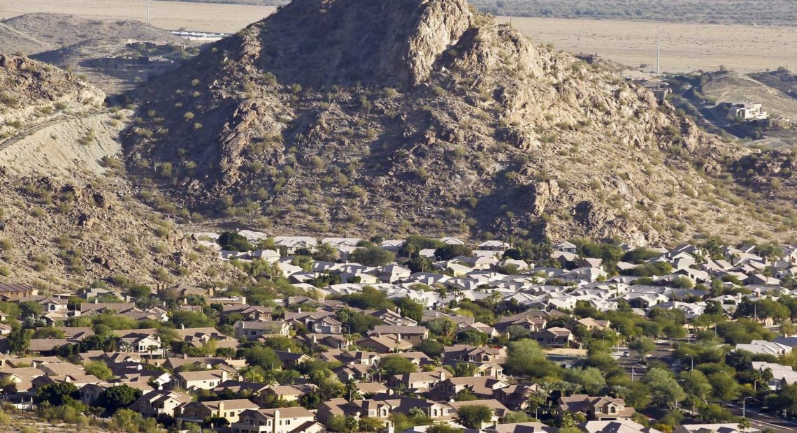 A housing development sits nestled in the South Mountain foothills in the Ahwatukee neighborhood, in Phoenix, Ariz. The city saw the biggest jump in population in the U.S. between 2017 and 2018. CREDIT: Ross D. Franklin/AP