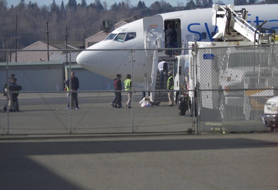 In this still image from a vide, detainees are loaded onto a Swift Air charter flight at King County International Airport (Boeing Field) in Seattle. COURTESY OF UWCHR/ALEX MONTALVO AND WADII BOUGHDIR