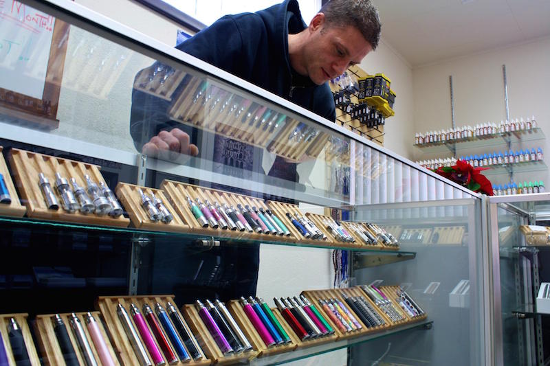 In this file video, the owner of a Spokane electronic cigarette store examines his display case. CREDIT: JESSICA ROBINSON / N3