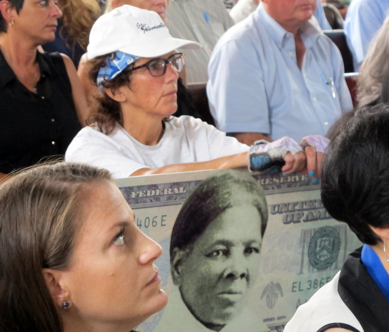 A woman holds a sign in 2015 supporting Harriet Tubman for the $20 bill during a town hall meeting at the Women's Rights National Historical Park in Seneca Falls, N.Y. CREDIT: CAROLYN THOMPSON/AP