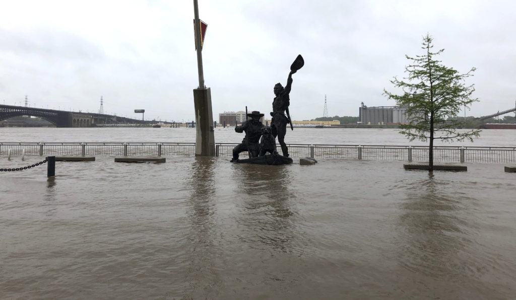 A statue of explorers Lewis and Clark is surrounded by floodwaters along the St. Louis riverfront on Thursday. CREDIT: Jim Salter/AP