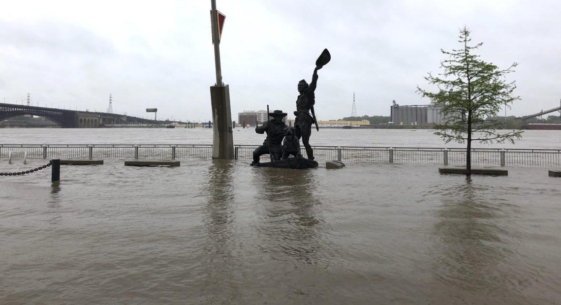 A statue of explorers Lewis and Clark is surrounded by floodwaters along the St. Louis riverfront on Thursday. CREDIT: Jim Salter/AP