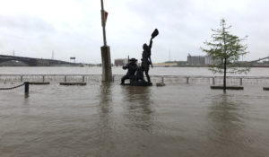 A statue of explorers Lewis and Clark is surrounded by floodwaters along the St. Louis riverfront on Thursday. CREDIT: Jim Salter/AP