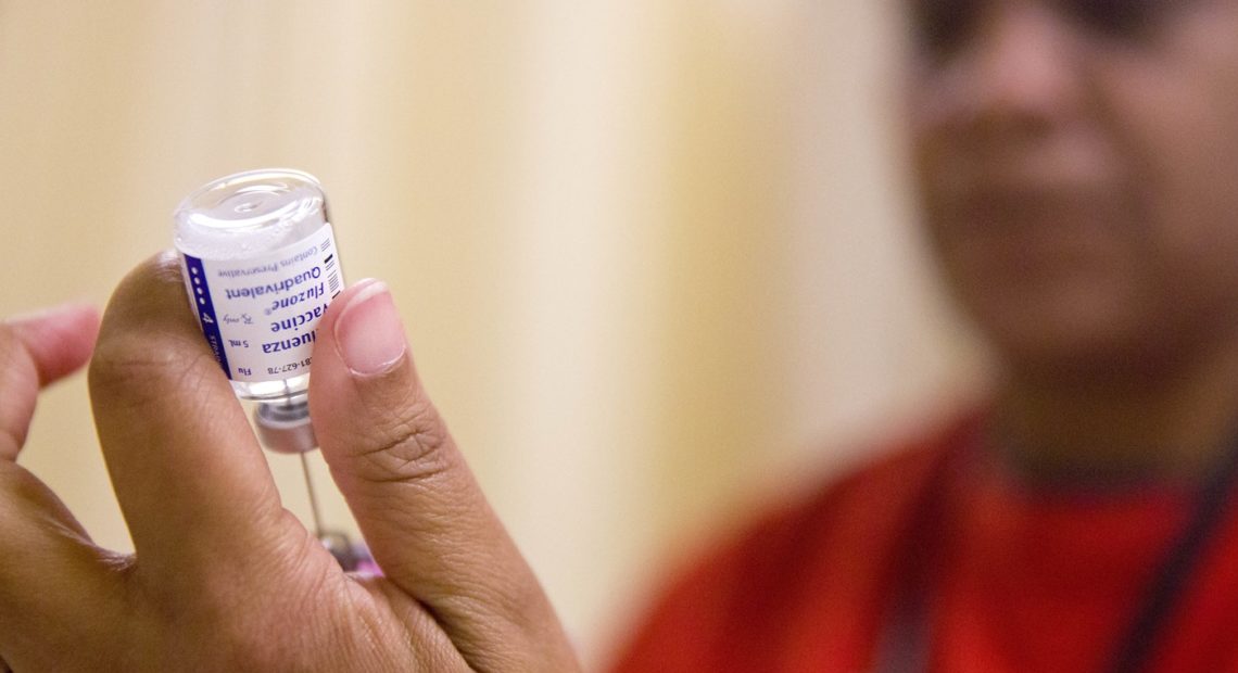 A nurse prepares a flu shot from a vaccine vial at the Salvation Army in Atlanta. CREDIT: AP PHOTO/DAVID GOLDMAN