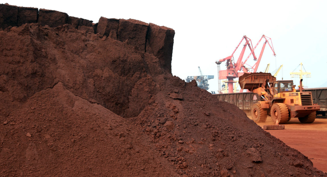 A worker in China shifts soil containing rare earth minerals intended for export in 2010. Rare earths are used in important technologies, and a commentary in China's People's Daily newspaper on Wednesday said the U.S. endangers its supply from China by waging a trade war. STR/AFP/Getty Images