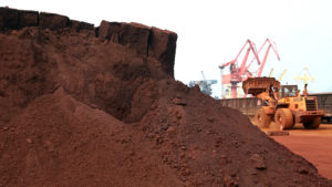 A worker in China shifts soil containing rare earth minerals intended for export in 2010. Rare earths are used in important technologies, and a commentary in China's People's Daily newspaper on Wednesday said the U.S. endangers its supply from China by waging a trade war. STR/AFP/Getty Images