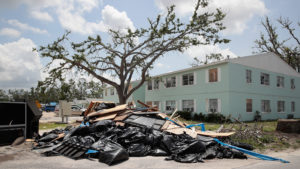 Debris is piled on May 10 outside an apartment complex that was damaged by Hurricane Michael in Panama City, Fla. Rep. Chip Roy objected to a procedural vote on a bipartisan $19.1 billion disaster aid bill, forcing Congress to wait until June to finish work on the legislation. Scott Olson/Getty Images