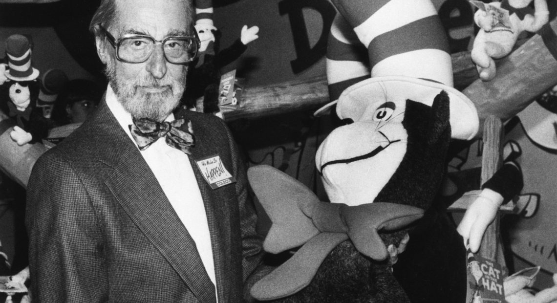 Theodor Geisel — Dr. Seuss --holds a toy of the Cat in the Hat, one of his most famous character creations.