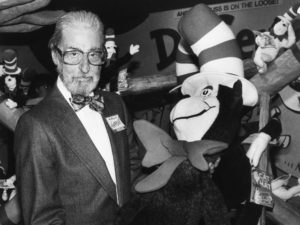 Theodor Geisel — Dr. Seuss --holds a toy of the Cat in the Hat, one of his most famous character creations.