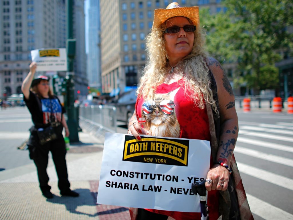 A woman holds up a sign during an anti-Sharia law rally organized by ACT for America. A new report finds that mainstream philanthropies are unknowingly funneling donations to anti-Muslim groups such as ACT for America. Kena Betancur /AFP/Getty Images