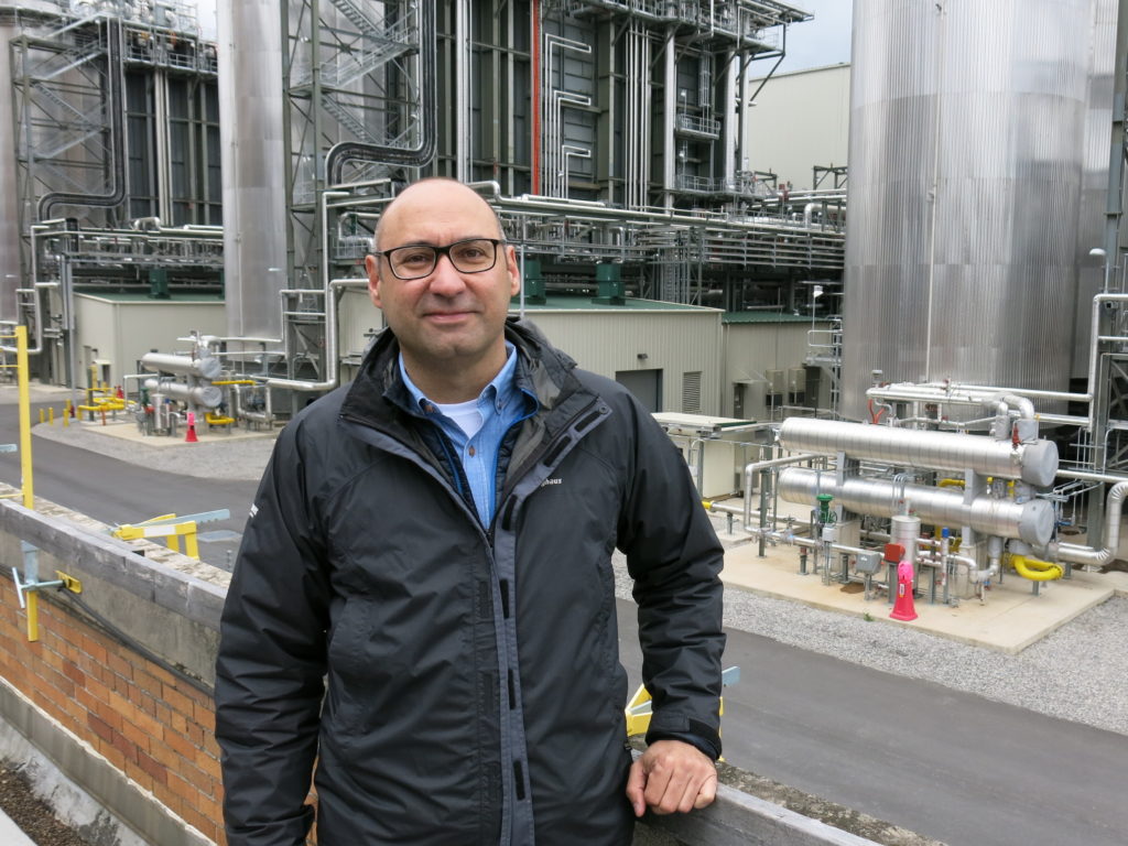Joe Zokaites with redevelopment firm Arcova stands in front of a natural gas power plant built next to the old coal plant. The new facility takes up a fraction of the space and produces nearly three times the electricity. CREDIT: JEFF BRADY/NPR
