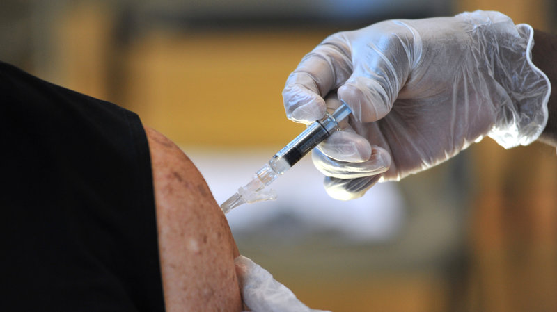 Many people might not be aware of what types of vaccines they need as they get older. Here, an adult gets a flu shot in Jacksonville, Fla. CREDIT: RICK WILSON/AP IMAGES