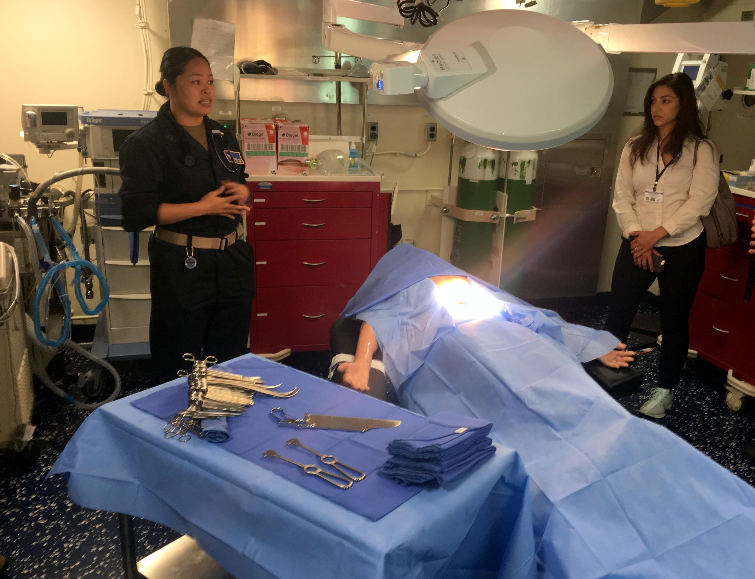 Senior medical officer Maria Gozo, left, stands in one of two operating rooms on board the USS Anchorage. CREDIT TOM BANSE / NORTHWEST NEWS NETWORK