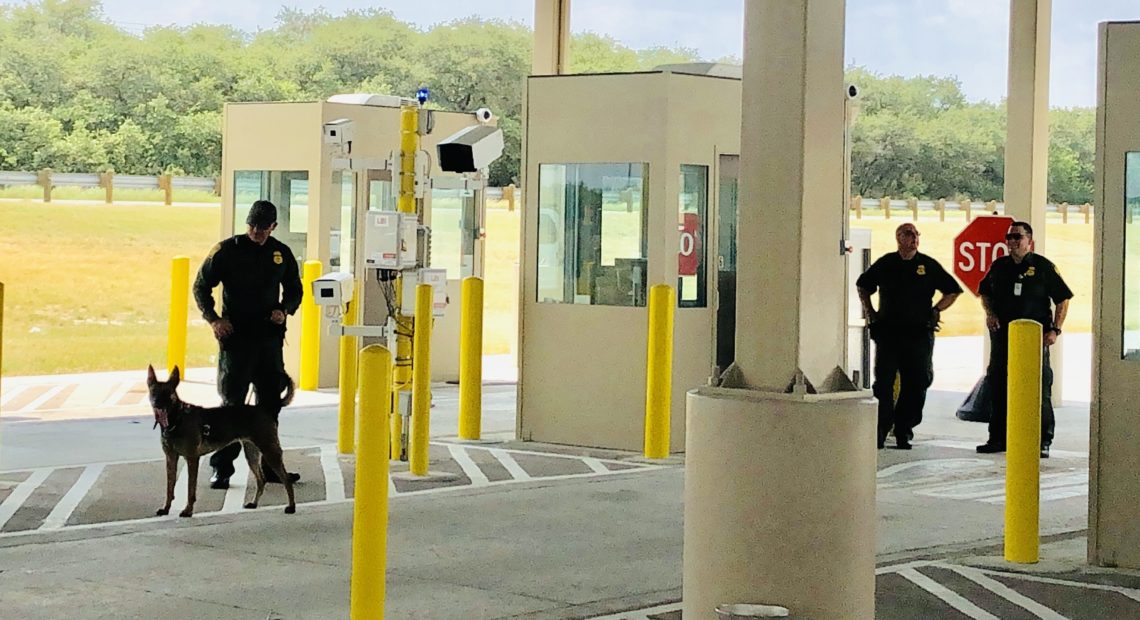 Border Patrol agents with a sniffer dog at the new and expanded Falfurrias checkpoint. Eric Westervelt/NPR