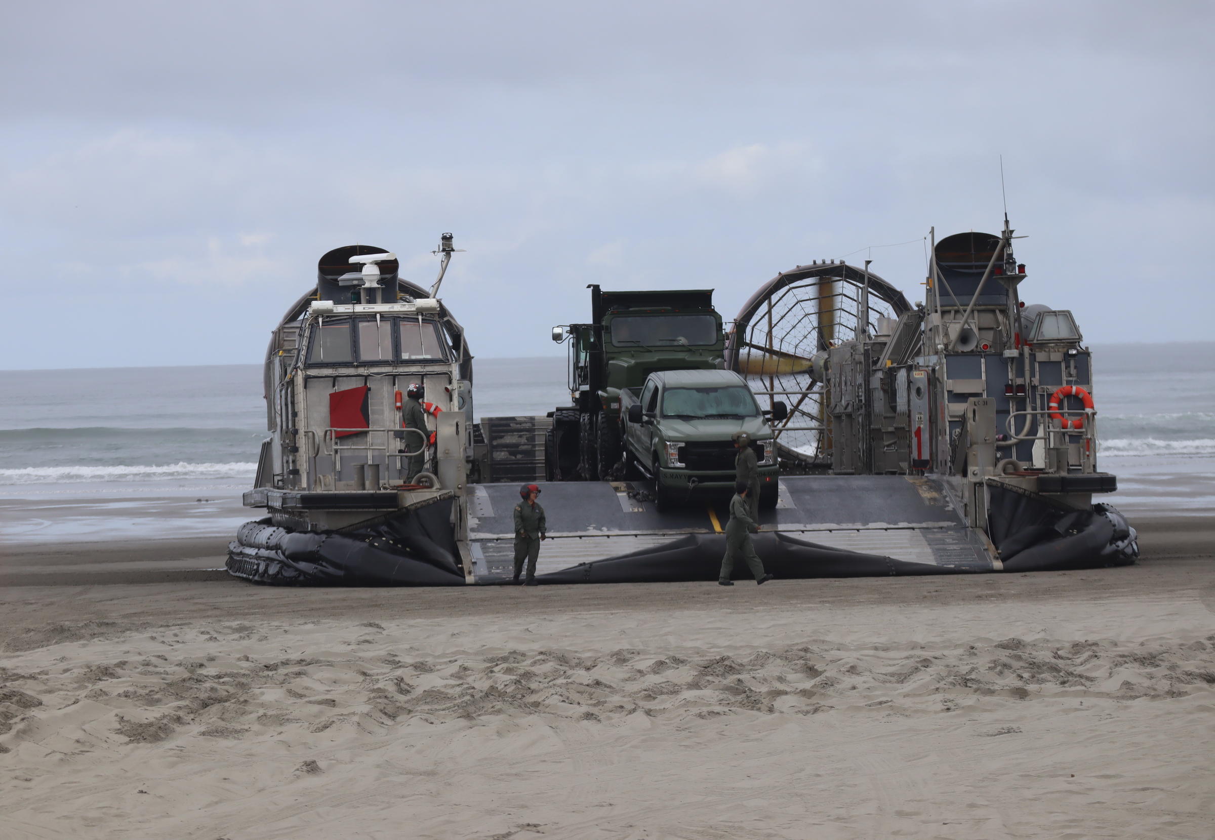 Navy hovercrafts deliver equipment, meant to clear roadways, during a mock Cascadia earthquake preparedness demonstration Monday. CREDIT TOM BANSE / NORTHWEST NEWS NETWORK