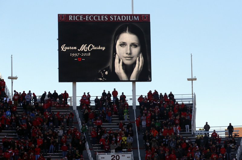 In this Nov. 10, 2018, file photo, a photograph of University of Utah student and track athlete Lauren McCluskey, who was fatally shot on campus, is projected on the video board before the start of an NCAA college football game between Oregon and Utah in Salt Lake City. The family of a University of Lauren McCluskey sued the institution on Thursday, June 27, 2019, saying officials have refused to take responsibility for missing chances to prevent her death despite multiple reports to police.