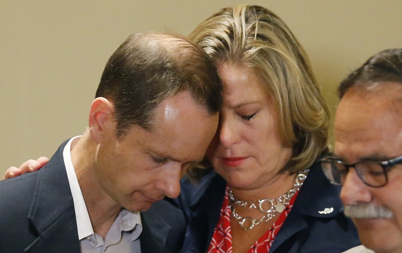 Matthew and Jill McCluskey hug after speaking during a news conference Thursday, June 27, 2019, in Salt Lake City. CREDIT: RICK BOWMER/AP