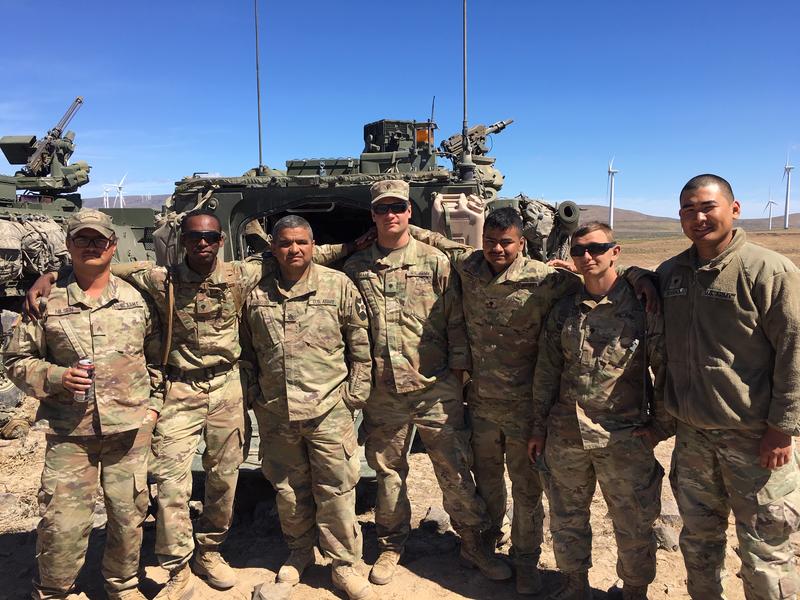 Spc. Joshua Junious, second from left, poses with members of his National Guard platoon at the Yakima Training Center. CREDIT: AUSTIN JENKINS/N3