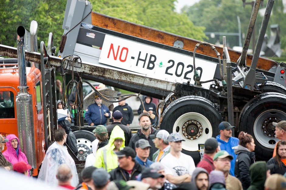A flatbed truck rides by as a crowd rallies at the Capitol in Salem to protest House Bill 2020. CREDIT: David Stuckey/OPB
