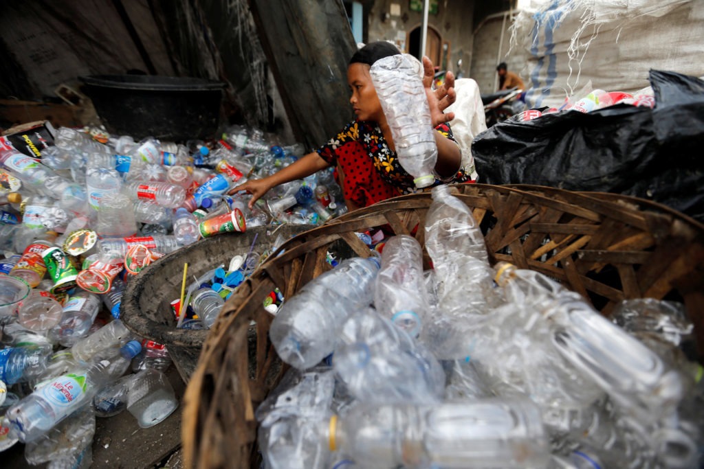 A woman sorts plastic bottles for recycling at Cilincing district in Jakarta, Indonesia. Since China stopped accepting most recyclables from other countries, Western nations have begun to ship more of their waste to Southeast Asia. CREDIT: BEAWIHARTA/REUTERS