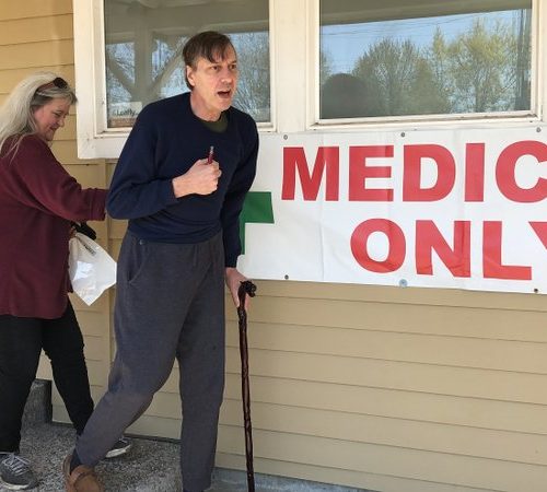 Scott Donnelly, assisted by his wife and licensed caregiver, Vicki Poppen, leaves Western Oregon Dispensary in Sherwood, Ore., after buying medical marijuana to treat muscle spasms caused by his multiple sclerosis. Donnelly visits the medical-only dispensary once a week and relies on it for the cannabis that eases his tremors long enough that he can fall asleep. The dispensary is one of two medical-only shops left in Oregon. CREDIT: GILLIAN FLACCUS/AP