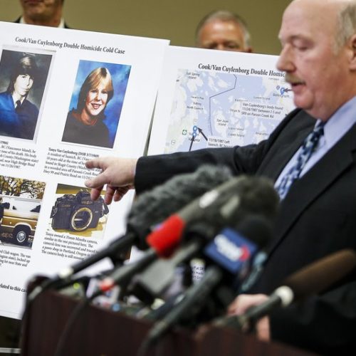 In this April 11, 2018 photo, Snohomish County Cold Case Detective Jim Scharf, right, shares details of the unsolved case of the 1987 double homicide of Jay Cook and Tanya Van Cuylenborg. William Earl Talbott II is charged. CREDIT: Ian Terry/The Herald via AP