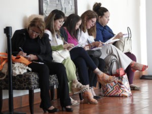 In this photo, women fill out job applications at a JobNewsUSA job fair in Miami Lakes, Fla. Lynne Sladky/AP