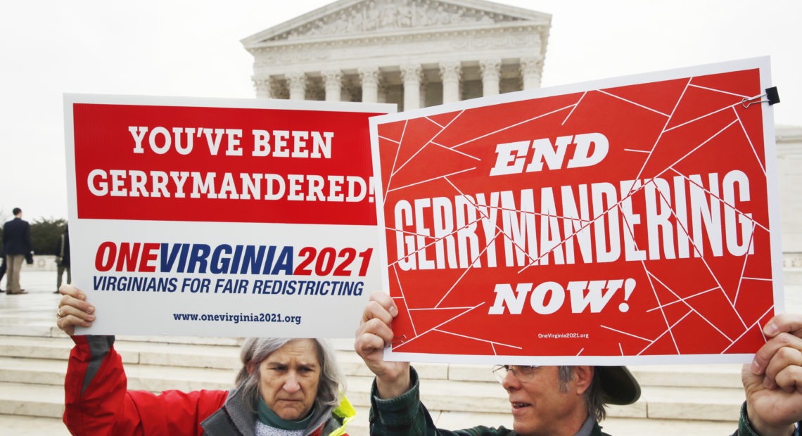 Sara Fitzgerald (left) and Michael Martin, both with the group One Virginia, protest gerrymandering in front of the Supreme Court in March. Jacquelyn Martin/AP