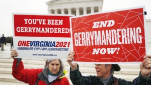 Sara Fitzgerald and Michael Martin, both with the group One Virginia, protest gerrymandering in front of the Supreme Court in March 2018. Jacquelyn Martin/AP