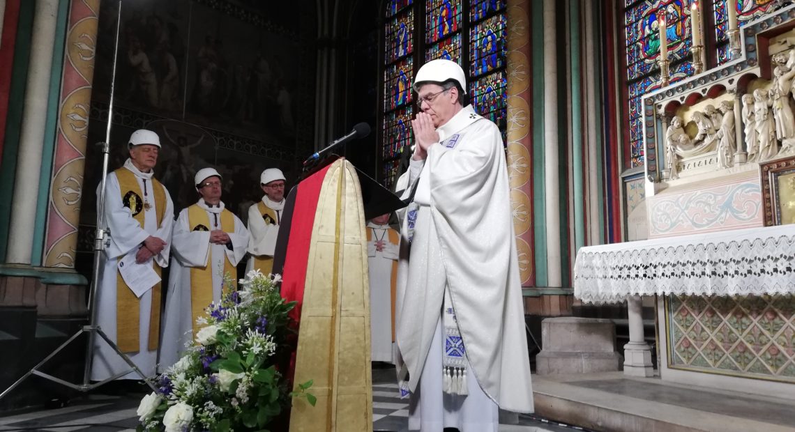 A small group in hard hats gathered on Saturday for Mass in Paris' Notre Dame cathedral. It was the first Mass since a fire devastated the church in April. Karine Perret/AFP/Getty Images