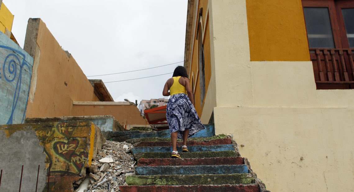 A woman walks through La Perla, a neighborhood on the edge of Old San Juan, in 2017. AFP Contributor/Getty Images