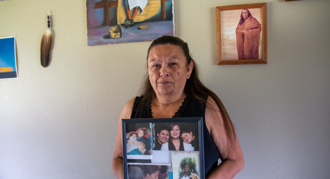 Vicky Jefferson holds a framed montage of photos of her daughter Shannon who died by suicide in the Whatcom County Jail. CREDIT: SARAH WALLACE