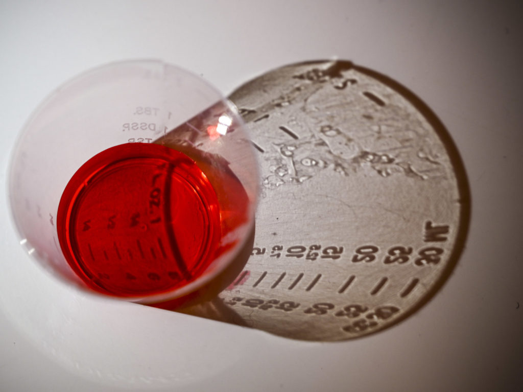 A 5ml dose of liquid oxycodone, an opioid pain relief medication, sits on a table in Washington, D.C., March 29, 2019. During the opioid epidemic, roughly 218,000 Americans have died from overdoses tied to prescription pain pills, according to the Centers for Disease Control and Prevention. EVA HAMBACH/AFP/Getty Images