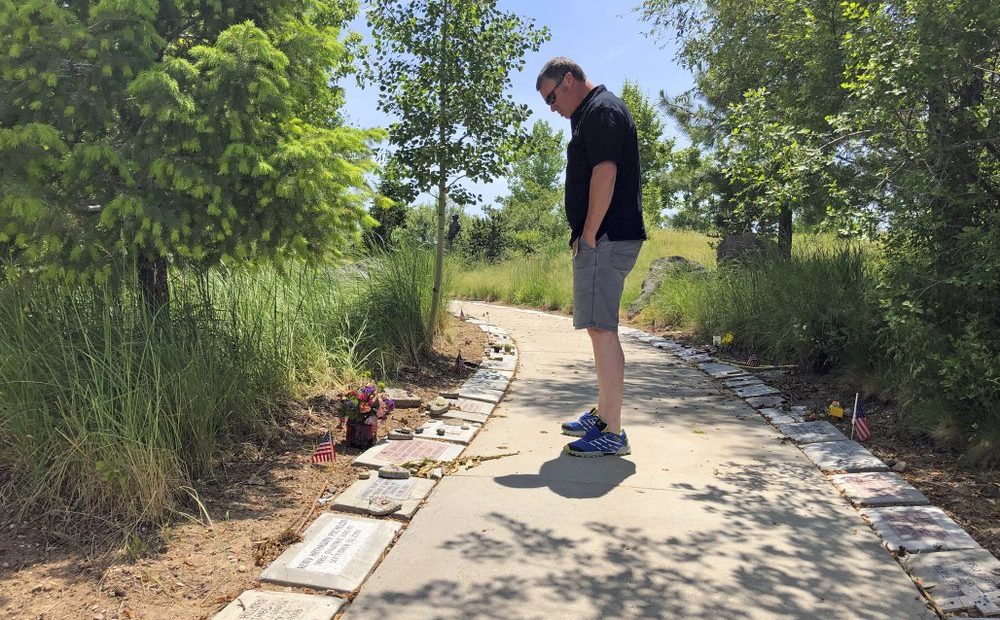 Bill Arsenault of the Idaho Falls Fire Department looks at memorial stones at the Wildland Firefighters Monument at the National Interagency Fire Center in Boise, Idaho. Federal officials at the NIFC are bolstering mental health resources for wildland firefighters following an apparent increase in suicides. CREDIT: KEITH RIDLER/AP
