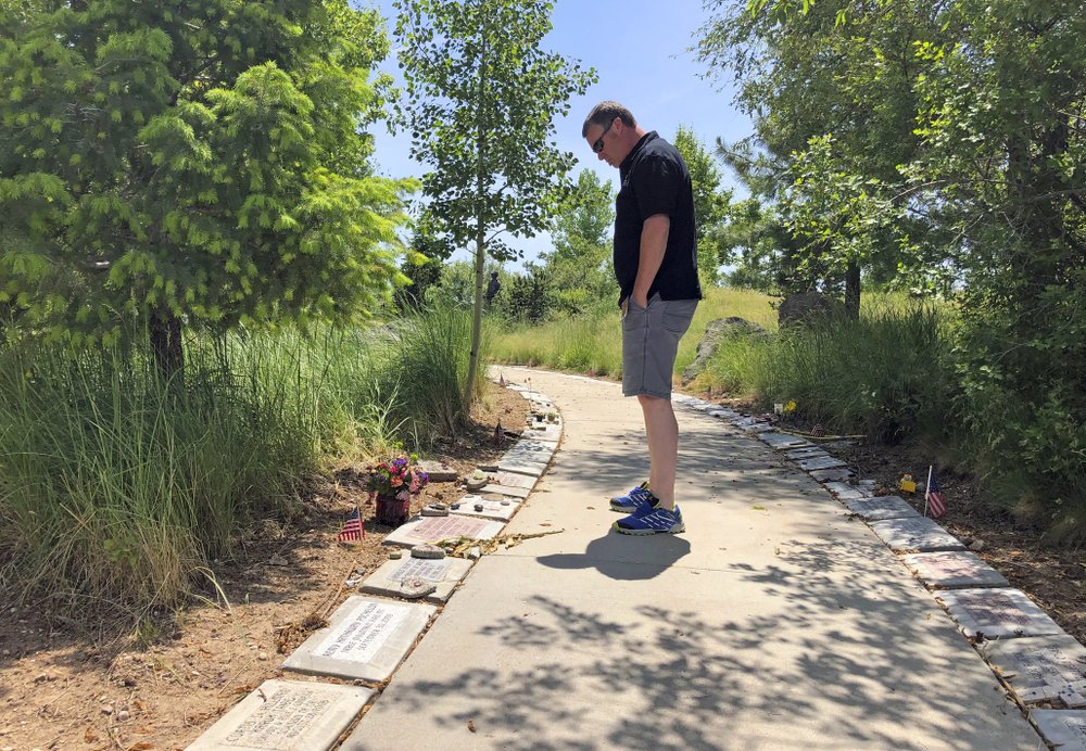 Bill Arsenault of the Idaho Falls Fire Department looks at memorial stones at the Wildland Firefighters Monument at the National Interagency Fire Center in Boise, Idaho. Federal officials at the NIFC are bolstering mental health resources for wildland firefighters following an apparent increase in suicides.  CREDIT: KEITH RIDLER/AP