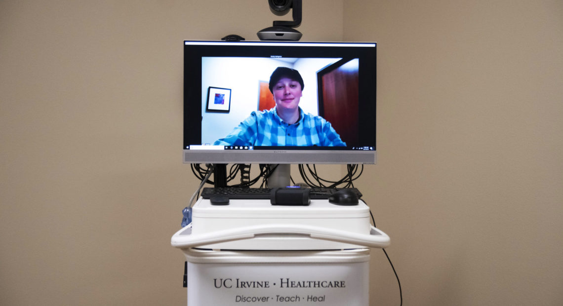 Coordinator Brandy Hartsgrove demonstrates how the telehealth connection works at The Chapa-de Indian Health Clinic in Grass Valley, Calif. Via this video screen, patients can consult doctors hundreds of miles away. CREDIT: Salgu Wissmath for NPR