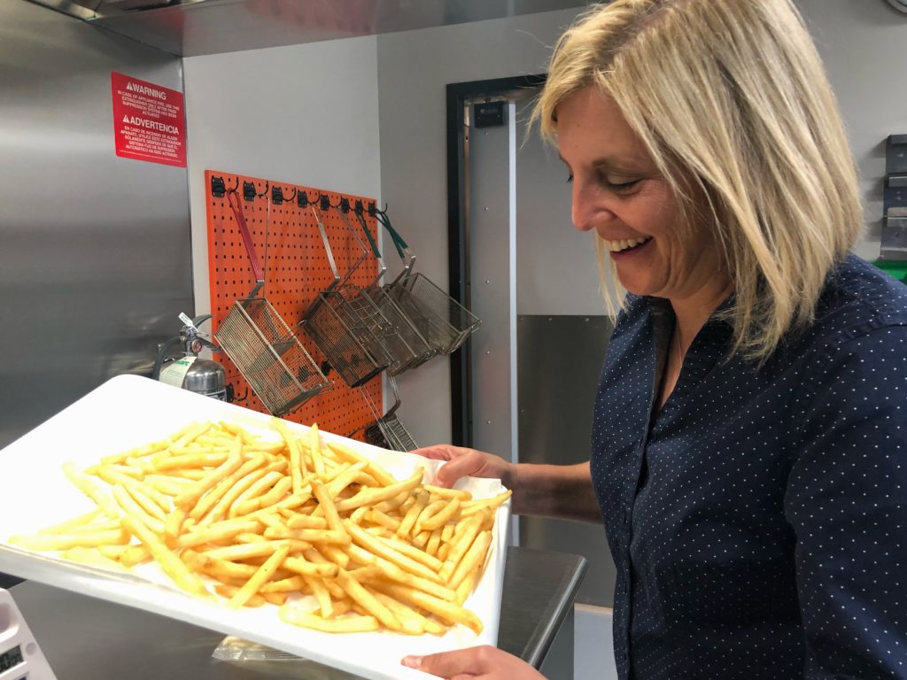 Deb Dihel is the head of innovation for Lamb Weston. She looks over some freshly fried Crispy on Delivery fries that she helped develop over the past several years. CREDIT: ANNA KING/N3