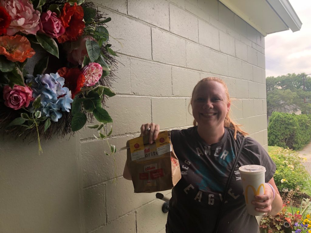 Food delivery driver Crystal Begallia delivers McDonald’s fries and cheeseburgers to Anna King’s door for a public radio experiment.