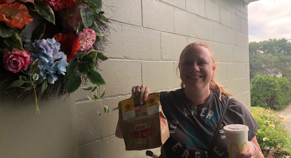 Food delivery driver Crystal Begallia delivers McDonald’s fries and cheeseburgers to Anna King’s door for a public radio experiment.