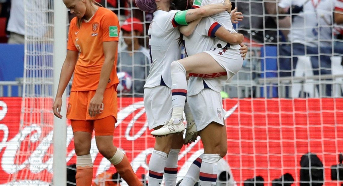 Netherlands' Anouk Dekker, left, walks past as United States' Rose Lavelle, right, celebrates with teammates after scoring her side's second goal during the Women's World Cup final soccer match between US and The Netherlands at the Stade de Lyon in Decines, outside Lyon, France on Sunday. Alessandra Tarantino/AP