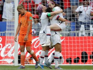 Netherlands' Anouk Dekker, left, walks past as United States' Rose Lavelle, right, celebrates with teammates after scoring her side's second goal during the Women's World Cup final soccer match between US and The Netherlands at the Stade de Lyon in Decines, outside Lyon, France on Sunday. Alessandra Tarantino/AP