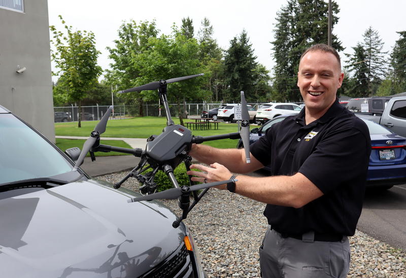 Tacoma-based Detective Sergeant Clint Thomas holds one of the Washington State Patrol's 111 drones, a DJI Matrice 200 model. CREDIT: TOM BANSE/N3