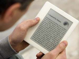 A man reads a book on his e-book reader device. In July, Microsoft will be deleting its e-book library and ceasing all e-book sales. Joerg Sarbach/Associated Press