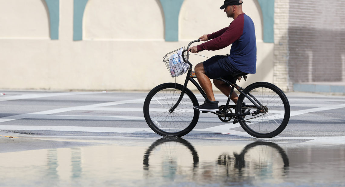 A street in Miami flooded during a high tide in 2018. A new report confirms that the number of days with high-tide flooding is increasing in many U.S. cities as sea levels rise. Wilfredo Lee/AP