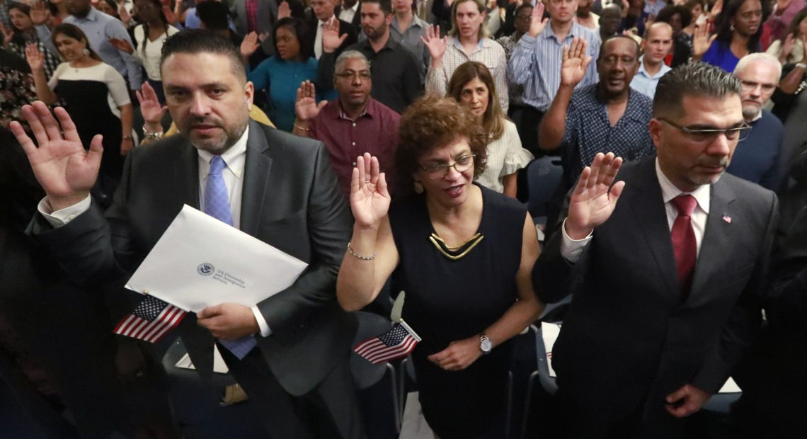 New citizens take the oath of allegiance during a naturalization ceremony in Oakland Park, Fla., earlier this year. The Trump administration has announced there will be changes to the U.S. citizenship test. CREDIT: Wilfredo Lee/AP