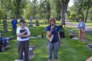 Two guides talk about the people buried at the cemetery. 