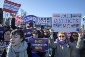 Protesters against gerrymandering at a March 2019 rally coinciding with Supreme Court hearings on major redistricting cases. After the court said the federal judiciary has no role in partisan redistricting cases, legal action is focused on state courts. Tasos Katopodis/Getty Images