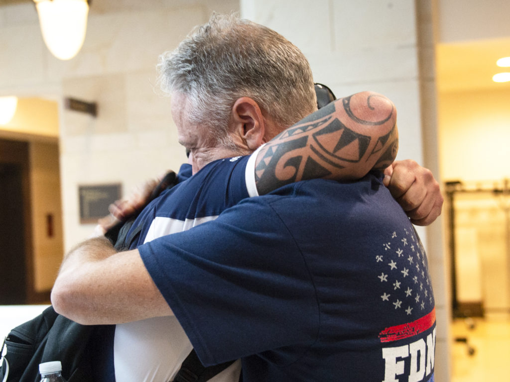 Sept. 11 first responder John Feal (left) and Jon Stewart, former host of The Daily Show, hug after the Senate passed a bill for extending the September 11th Victim Compensation Fund in Washington on Tuesday. Caroline Brehman/CQ-Roll Call