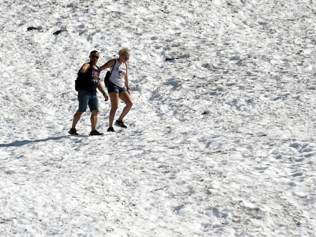 People hike on the Byron Glacier on Thursday in Girdwood, Alaska, southeast of Anchorage. Many cities set heat records amid unusually hot and dry conditions in the area. CREDIT: Lance King/Getty Images